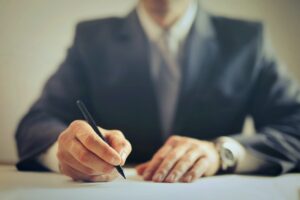 businessman signing a contract in an office